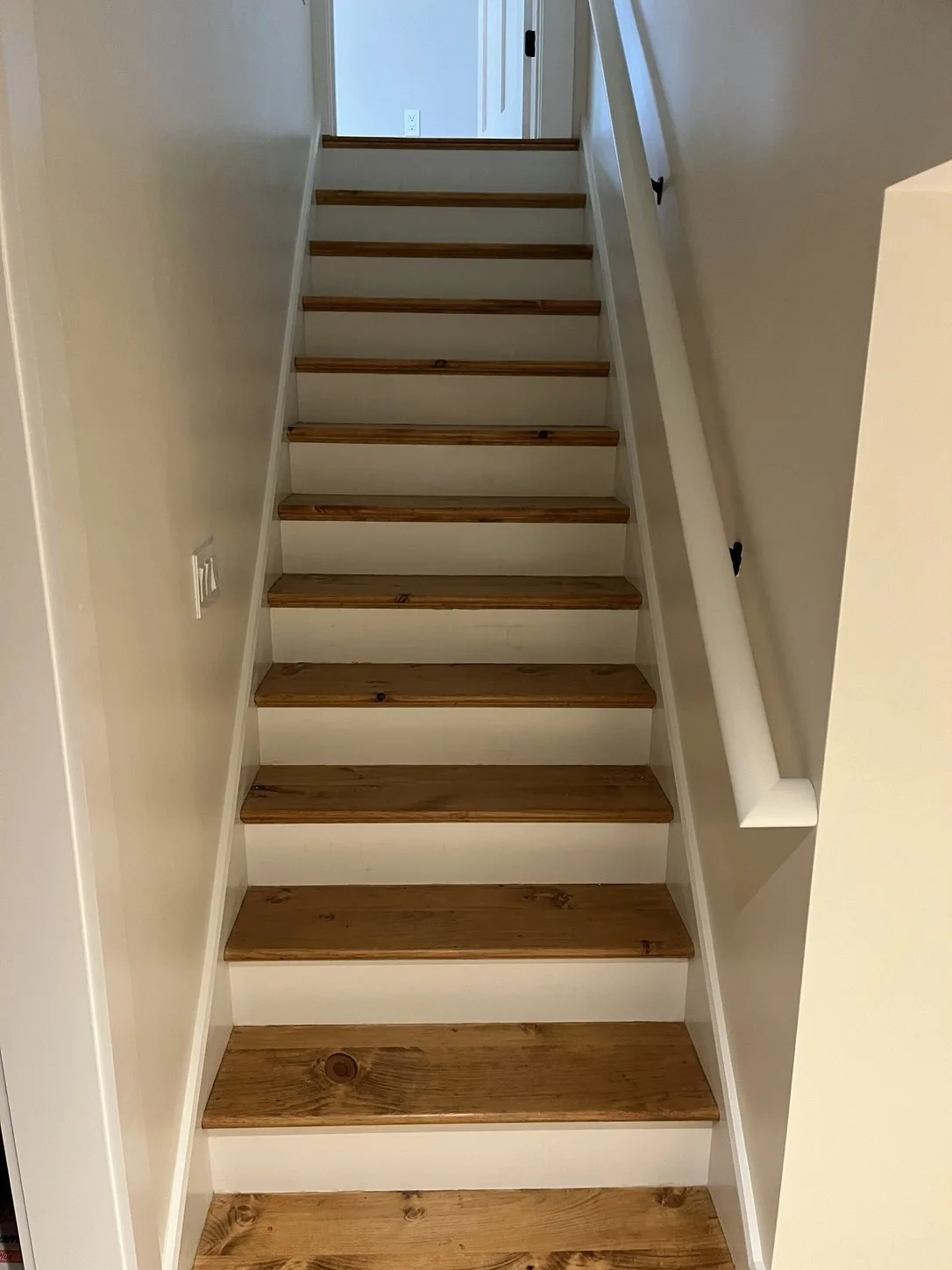 The same staircase with white oak treads and painted risers